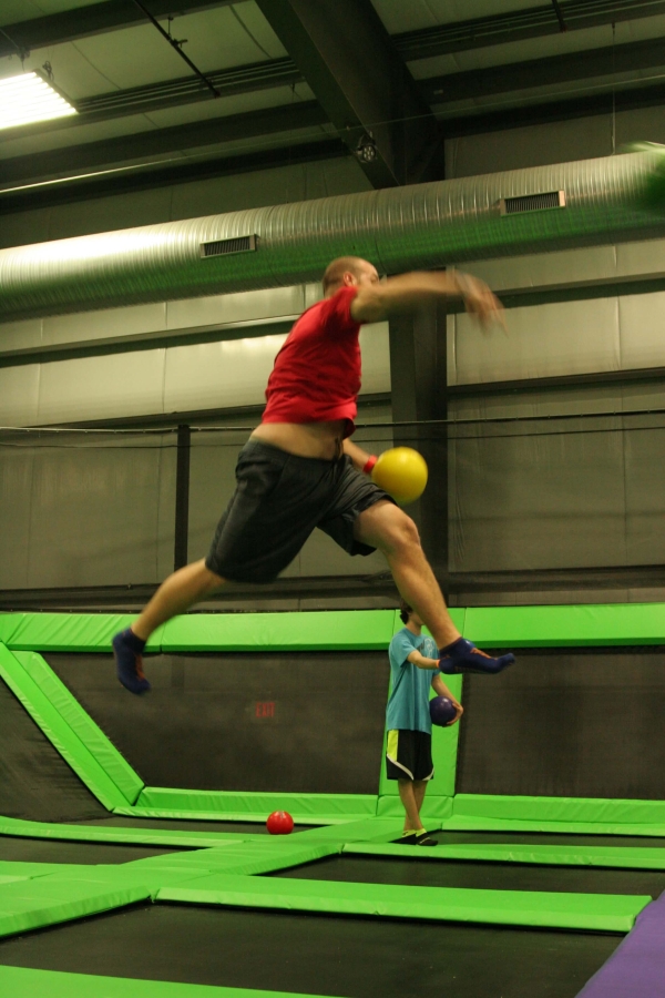 Guy Jumping and Throwing on a Trampoline